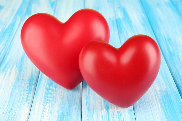 Decorative red hearts on color wooden background — Stock Photo, Image