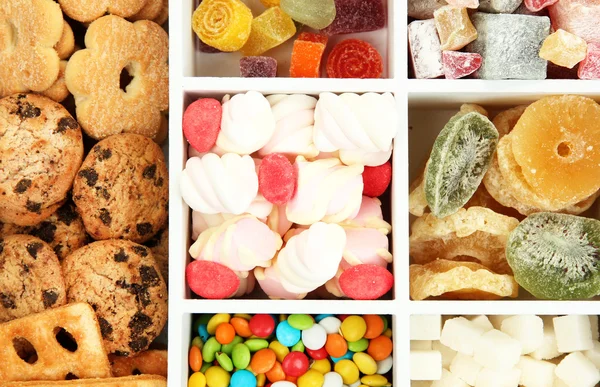 Multicolor candies and cookies in white wooden box close up — Stock Photo, Image