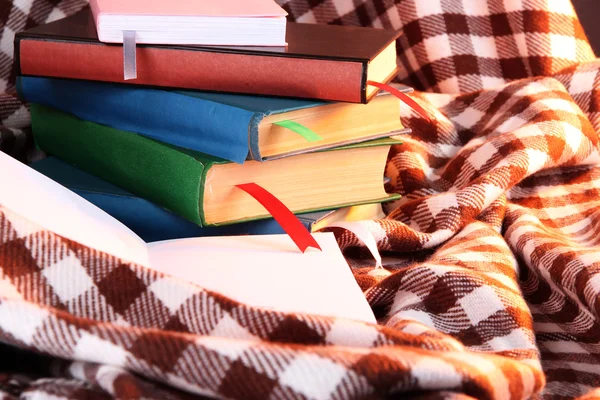 Many books with bookmarks on plaid — Stock Photo, Image