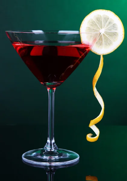 Cocktail rouge en verre de martini sur fond vert foncé — Photo