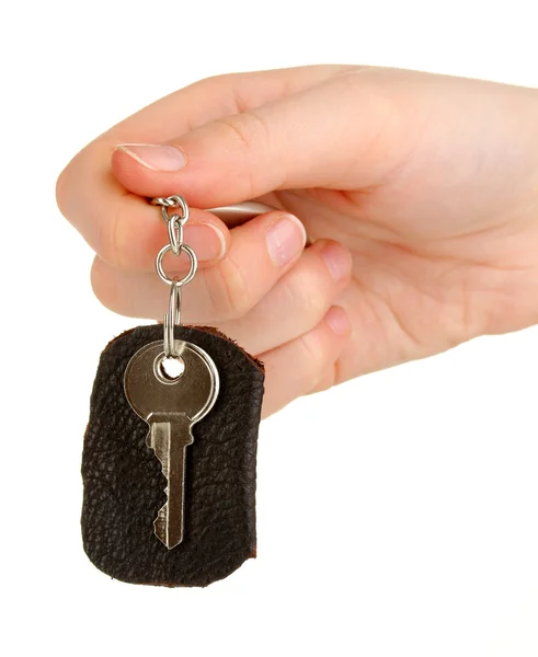 Key with leather trinket in hand isolated on white — Stock Photo, Image