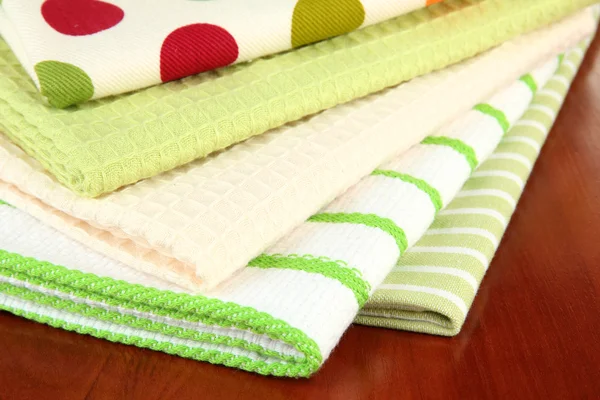 Kitchen towels on wooden background — Stockfoto