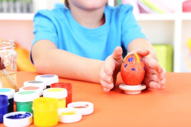 Çocuğun elinde tutan boyalı Paskalya yortusu yumurta