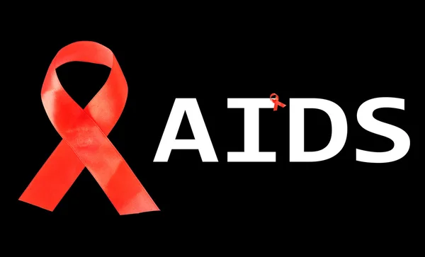 Aids awareness red ribbon isolated on black — Stock Photo, Image