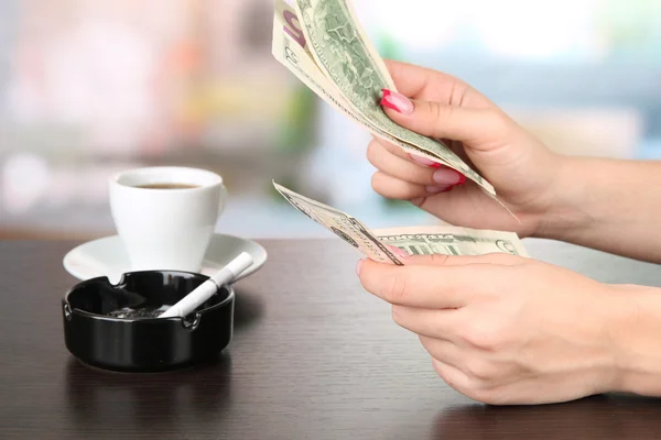 Female hands with money, on bright background — Stock Photo, Image