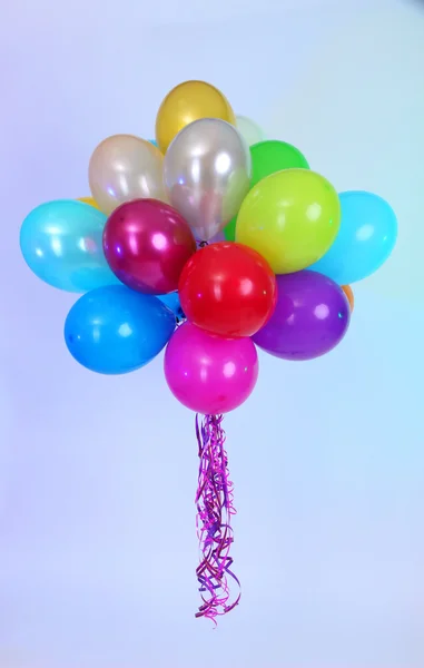 Many bright balloons on blue background — Stock Photo, Image