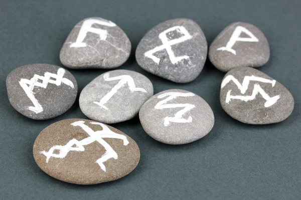 Fortune telling with symbols on stones on grey background — Stock Photo, Image