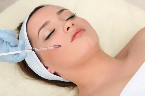 Young woman receiving plastic surgery injection on her face close up — Stock Photo, Image