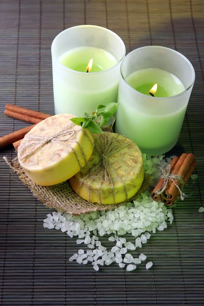 Hand made soap and candles on bamboo mat background — Stock Photo, Image