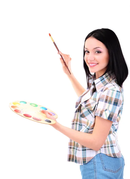 Beautiful young woman painter with brushes and palette at work, isolated on white — Stock Photo, Image