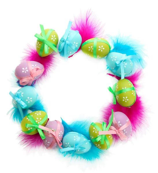 Wreath of bright easter eggs and decorative feathers, isolated on white — Stock Photo, Image