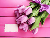 Картина, постер, плакат, фотообои "beautiful bouquet of purple tulips on pink wooden background", артикул 24430149