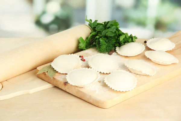 Raw dumplings and dough, on wooden table — Stock Photo, Image