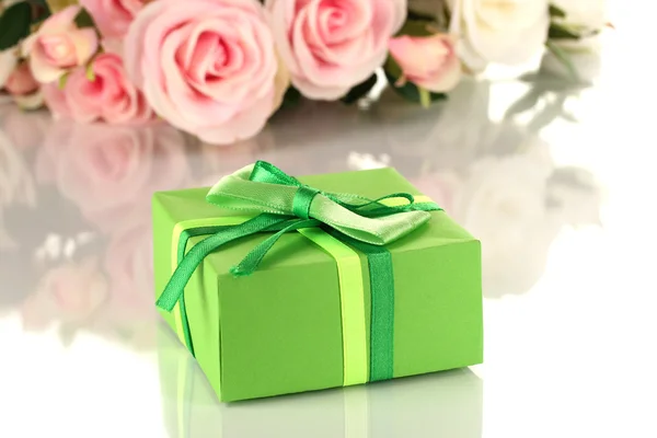 Beautiful gift on flowers background isolated on white — Stock Photo, Image