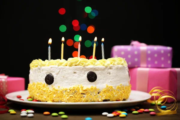 Happy birthday cake and gifts, on black background — Stock Photo, Image