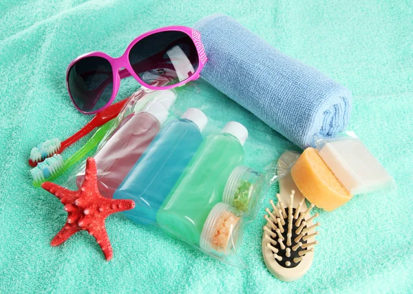 Hotel cosmetics kit on blue towel — Stock Photo, Image