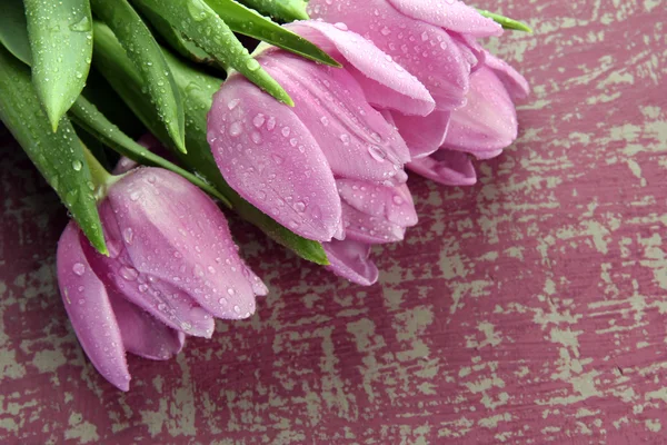 Beautiful bouquet of purple tulips on bright background — Stock Photo, Image