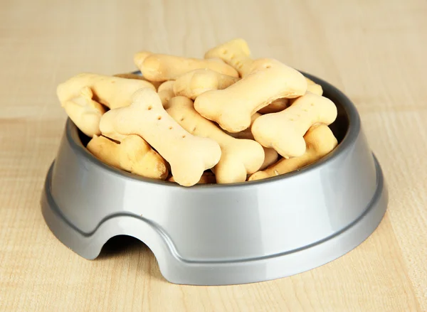 Dry dog food in bowl on wooden background — Stock Photo, Image