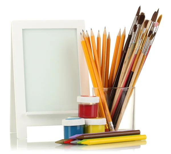 Photo frame as easel with artist's tools isolated on white — Stock Photo, Image