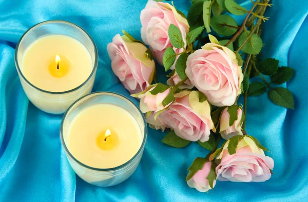 Candles on blue fabric close-up — Stock Photo, Image
