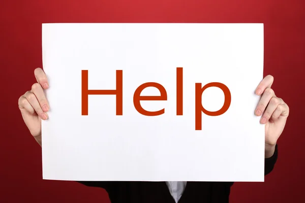 Woman holding paper with text in front of her face, on color background — Stock Photo, Image