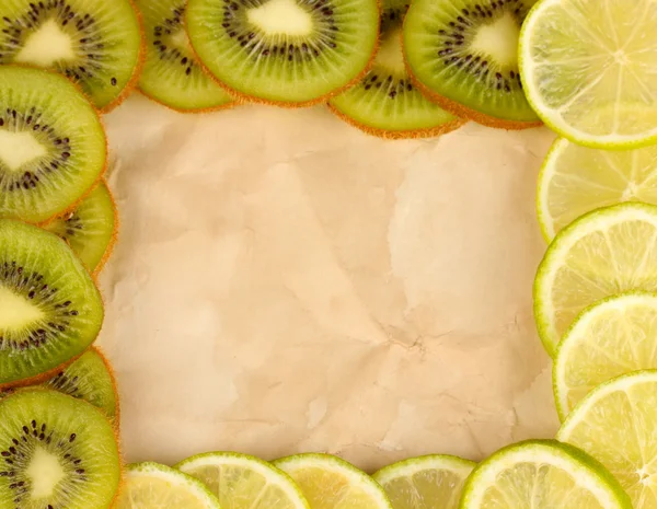 Lime and kiwi fruit slices frame on color background — Stock Photo, Image