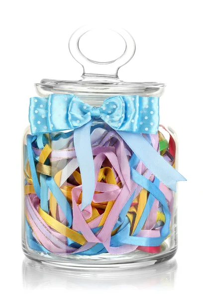 Glass jar containing various colored ribbons isolated on white — Stock Photo, Image