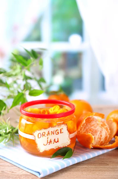 Orange jam with zest and tangerines, on wooden table — Stock Photo, Image