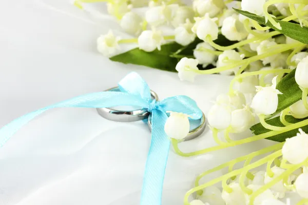 Wedding rings tied with ribbon on light gentle background — Stock Photo, Image