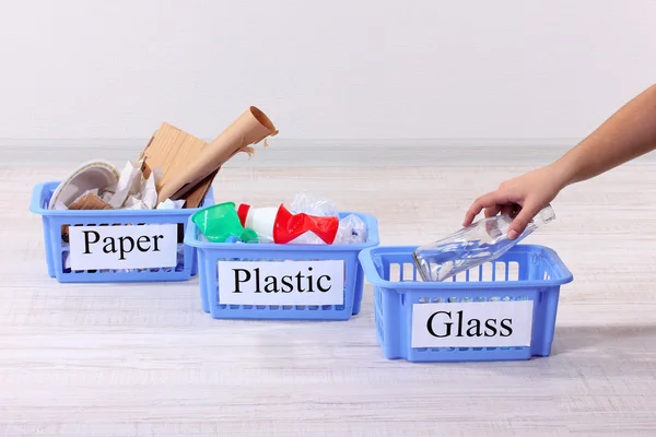 Three baskets of assorted debris on room background — Stock Photo, Image