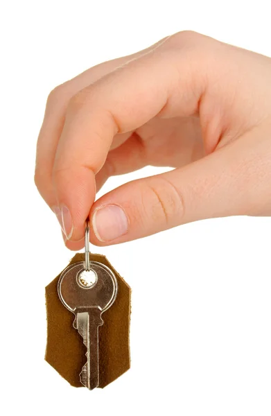 Key with leather trinket in hand isolated on white — Stock Photo, Image