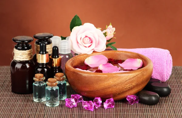 Spa composition with aroma oils on brown background — Stock Photo, Image