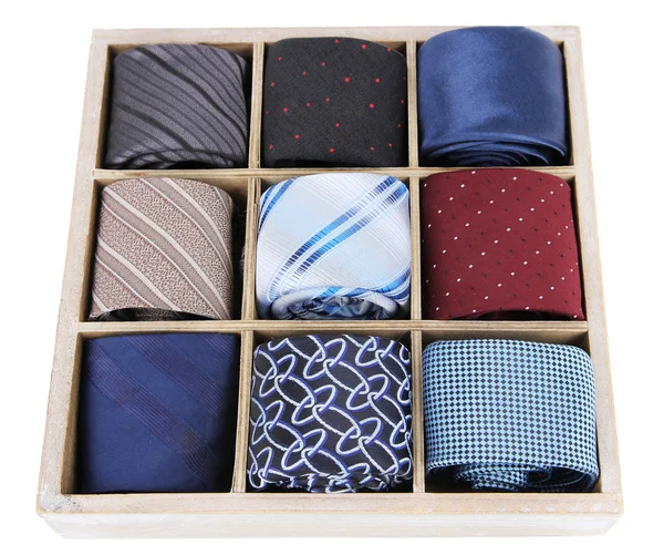 Neckties in wooden box isolated on white — Stok fotoğraf