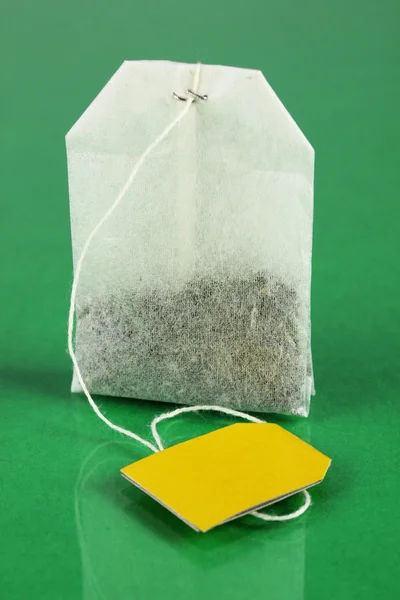Tea bag on green background — Stock Photo, Image