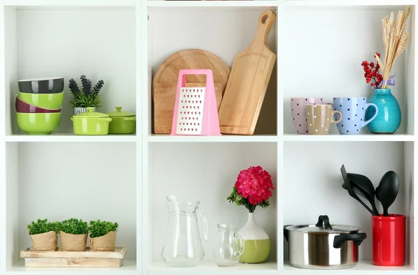 Beautiful white shelves with tableware and deco — Stock Photo, Image