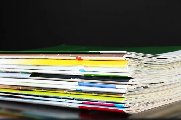 Many magazines isolated on black — Stock Photo, Image