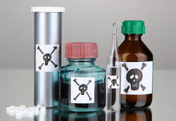 Deadly poison in bottles on grey background