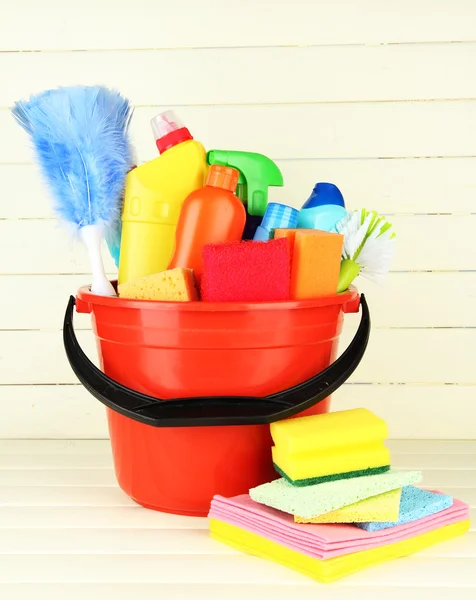 Cleaning items in bucket on white wooden background — Stock Photo, Image