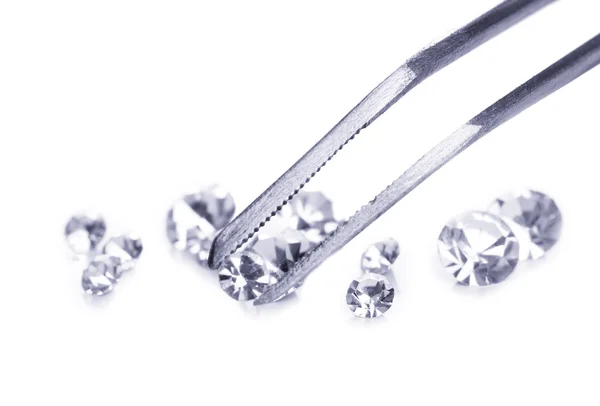 Beautiful shining crystal (diamond) in the tweezers, isolated on white — Stock Photo, Image