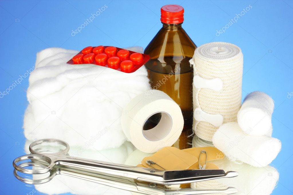 First aid kit for bandaging on blue background