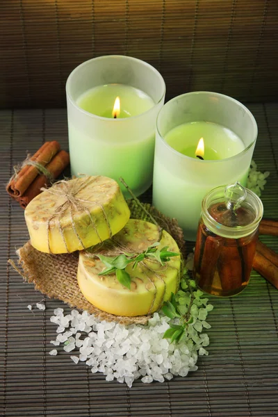 Hand made soap and candles on bamboo mat background — Stock Photo, Image