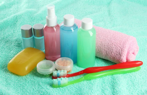 Hotel cosmetics kit on blue towel — Stock Photo, Image