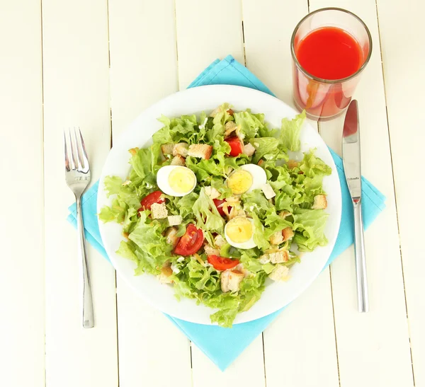 Ensalada César sobre plato blanco, sobre fondo de madera color —  Fotos de Stock