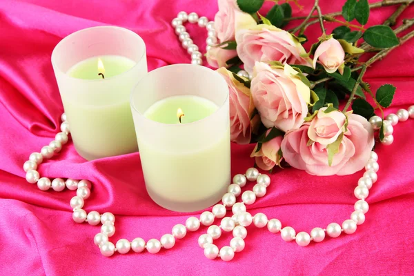 Candle on pink fabric close -up — Stock Photo, Image