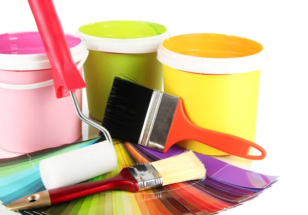 Paint pots, paintbrushes and coloured swatches — Stock Photo, Image