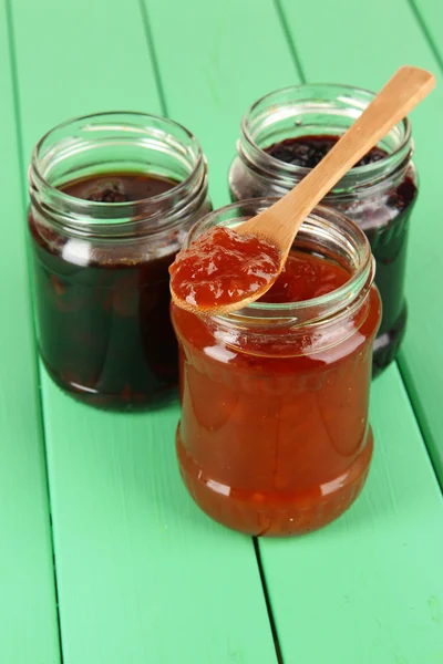 Tasty jam in banks on table — Stock Photo, Image