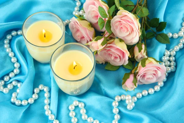 Candles on blue fabric — Stock Photo, Image