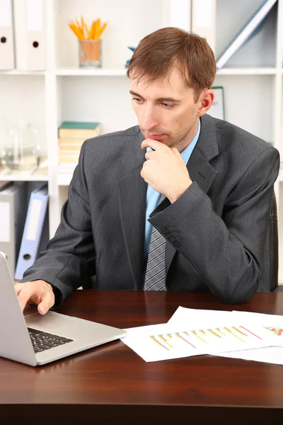 Young businessman in office at his workplace — Stock Photo, Image