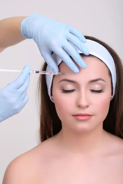 Young woman receiving plastic surgery injection — Stock Photo, Image