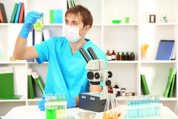 Assayer during research on room background — Stock Photo, Image